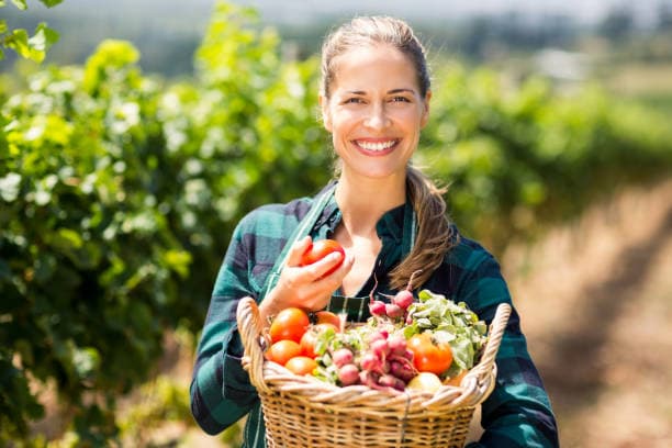 Smiling woman in agricultural field
